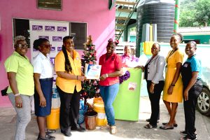 Sophie’s Place Administrator, Christine Madden-Watson, (centre), smiles as she accepts gift packages from 138SL Public Relations & Marketing Manager, Karelle McCormack during the team’s recent visit. Sophie’s Place which is located along the Gordon Town main road, is another of the facilities which is treated annually by the company. Looking on are members of the 138SL team (from left), Resident Relations Chief, Marva Thompson, Security Supervisor, Janet Blair, Human Resources Manager, Cheryl Clarke, Executive Assistant to the CEO, Angella Nelson, Human Resources Assistant, Lisa Minott and Accountant, Josephine Barton.